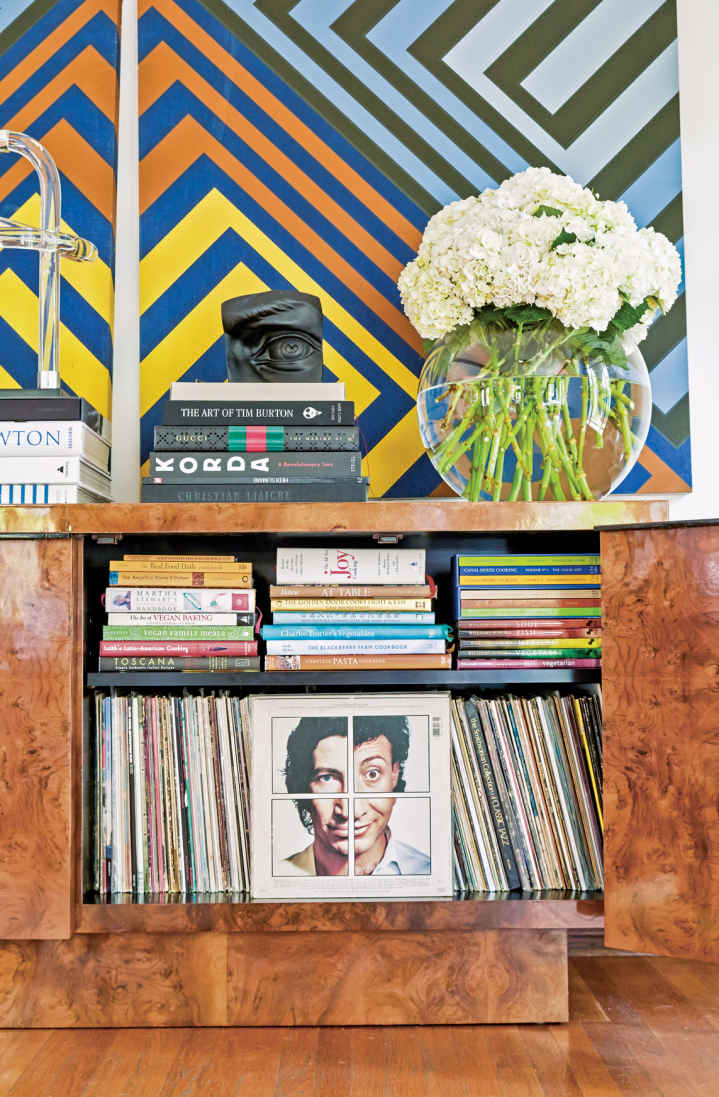 LET THERE BE MUSIC. This immense, burl wood credenza opens to reveal a curated record collection. The other side contains the turntable and digital stereo that connect to speakers throughout the house.
