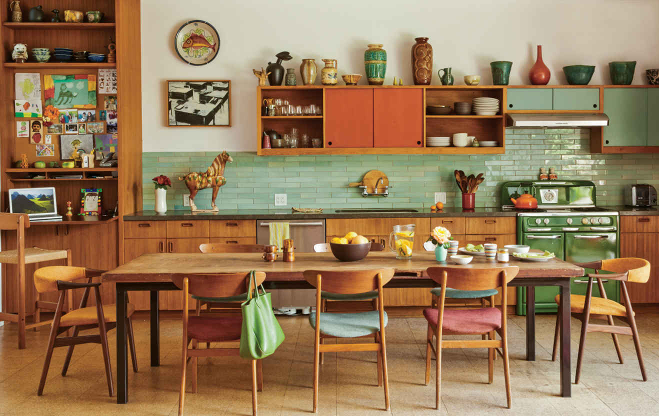 KITCHEN COMMANDO. Realizing that her happiest hours were spent in the kitchen, Judy had a small workstation built in to the far corner of the room. The secretary-style desk closes up when guests arrive.