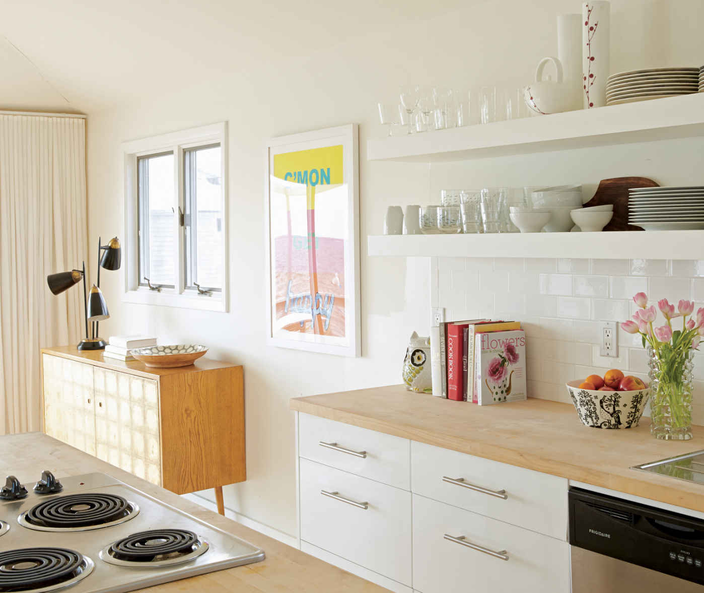 MAKE A SPLASH. For a crisp, modern look, nothing beats a white subway tile backsplash. This one was installed in straight, slightly offset lines that accentuate the gorgeous length of the kitchen.