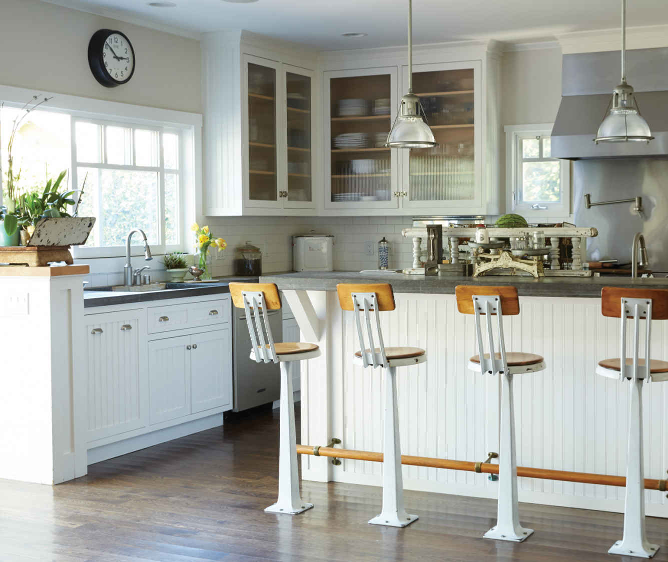 KITCHEN FOLIAGE. Homes glow when they include fresh flowers and plants. The tulips and potted succulents sprinkled around this kitchen lift spirits during post-meal dishwashing.