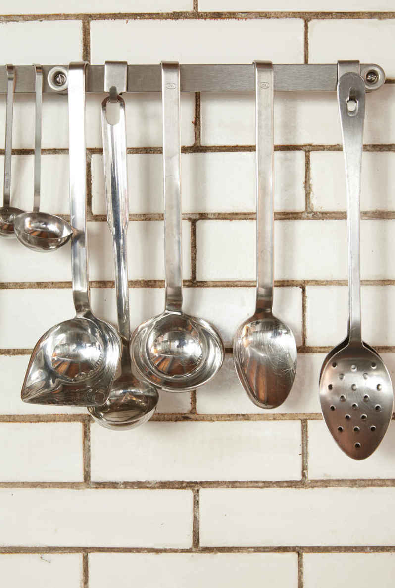 YOUR HOME, YOUR HOBBIES. Lisa and Joel love to cook, so having easy access to their most essential tools makes this kitchen “just right” for them. Factoring your passions into your design plans will always result in a place where you want to spend time.