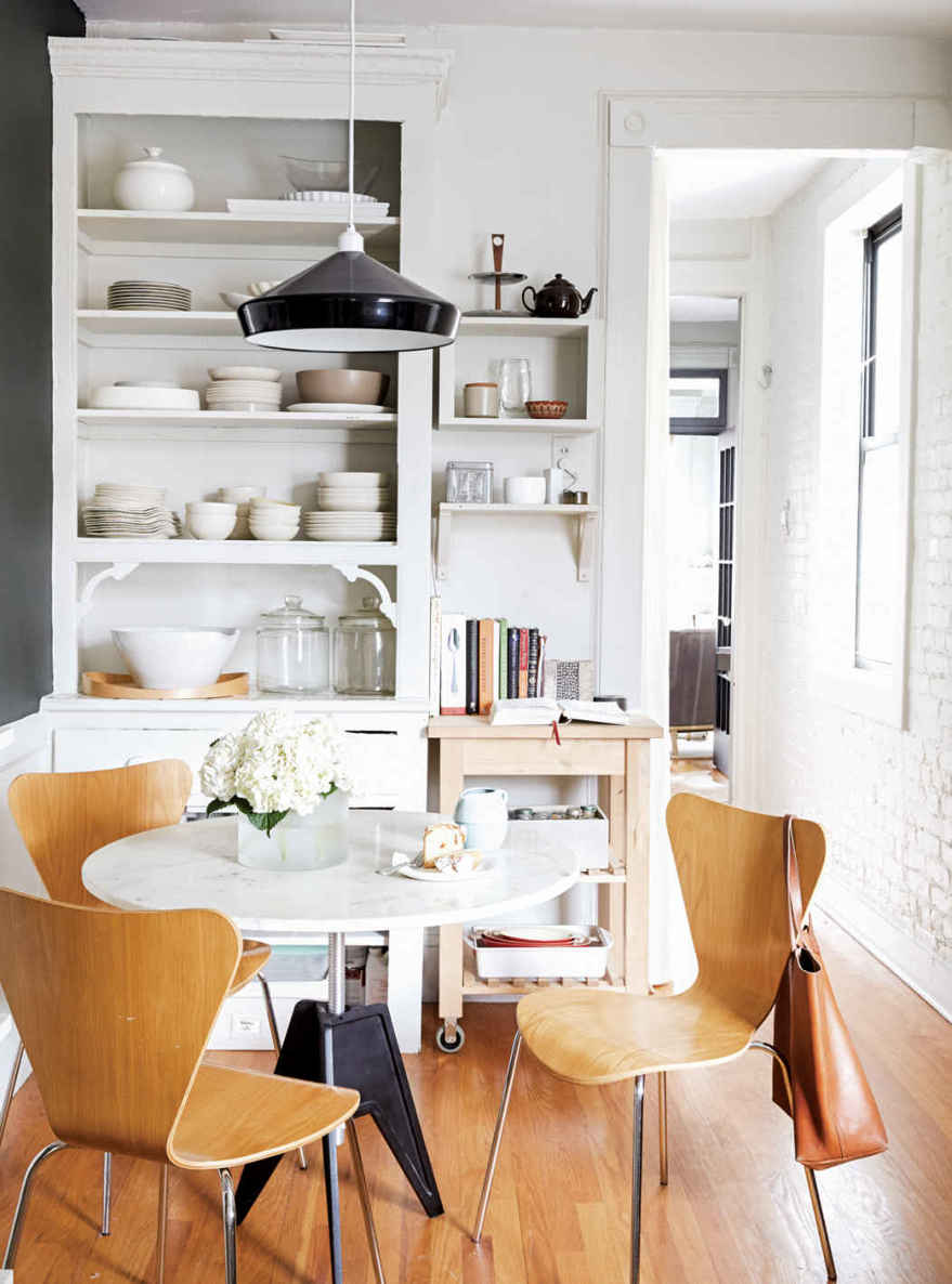 DISHING IT OUT. The curving shapes and off-white tones of Emily’s dishes allow everything to sit together harmoniously, even though the design sources are all over the place: Virginia Sin, Heath Ceramics, Simon Pearce, even IKEA.