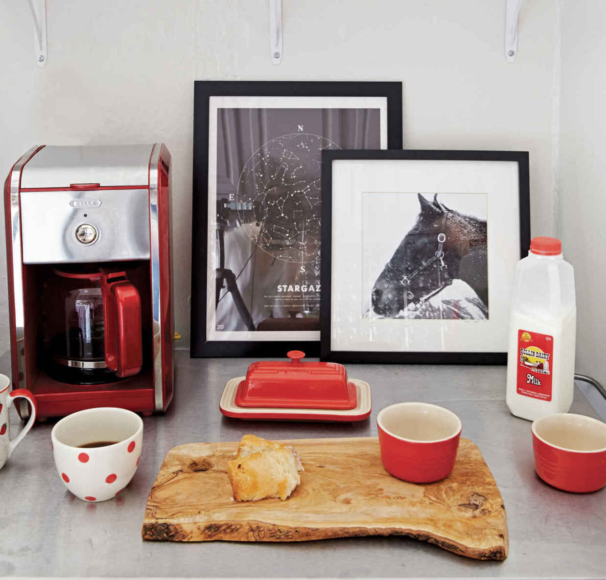 WHO NEEDS STARBUCKS? This adorable, color-coded coffee station is a caffeine lover’s dream. Storing “like” items (coffee mugs, coffeemaker, teapot, and so forth) in one spot increases a room’s functionality instantly.