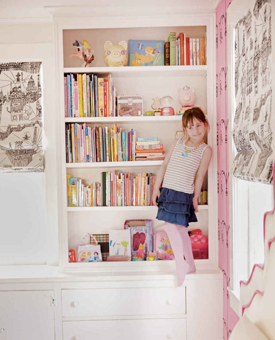 A PLACE TO PERCH. Original built-in cabinets, which include a desk and bookshelf, add some much-needed functionality to this minimally furnished room (when they’re not being used as an indoor jungle gym).