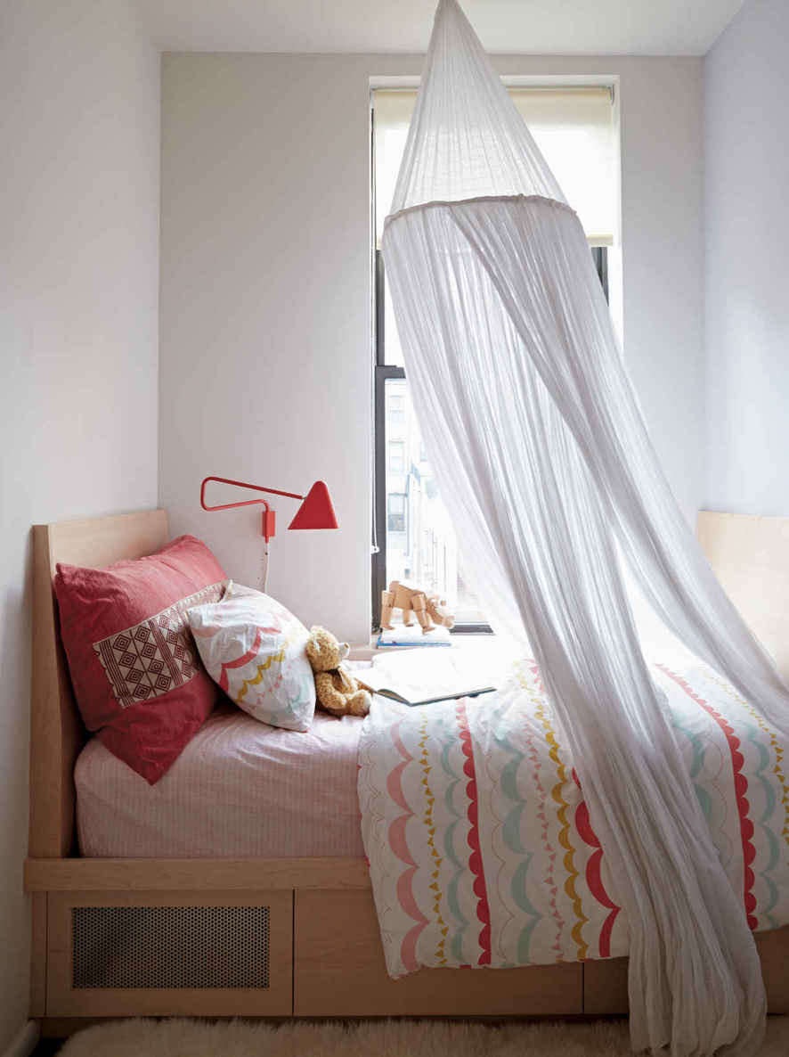 STAND-IN NIGHTSTAND. In lieu of a side table, which there wasn’t space for, a nightlight was mounted to the wall and a wide window shelf was used to hold books.