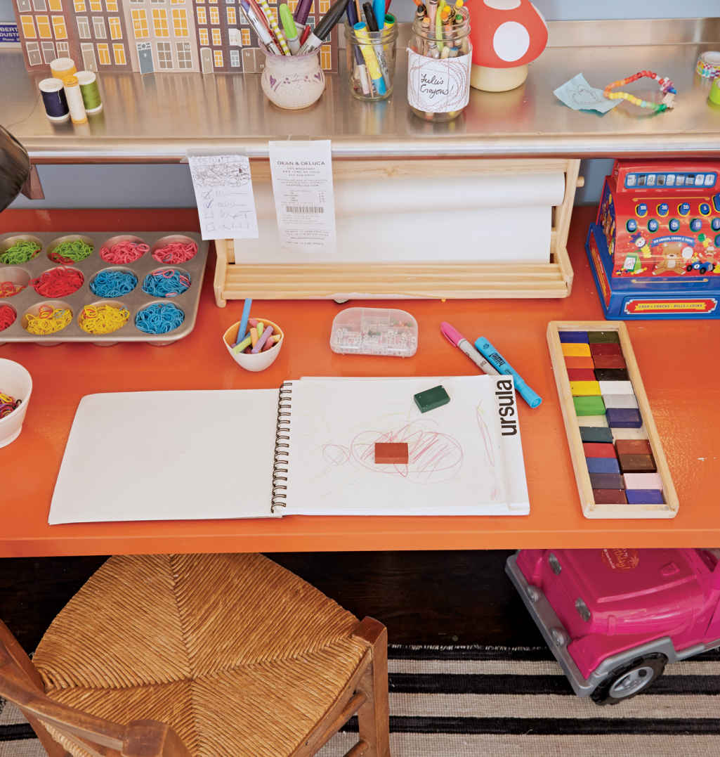 ORANGE SLICE. This desk is actually a solid wood IKEA countertop that’s been cut to size and covered with three coats of Farrow & Ball high-gloss paint.