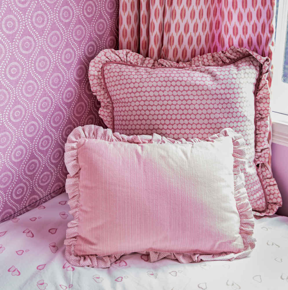 FIVE DEEP. Most designers would recommend sticking with two or three fabrics in a room—this one has five. It works because the simple prints and edited color scheme keep the individual fabrics from competing.