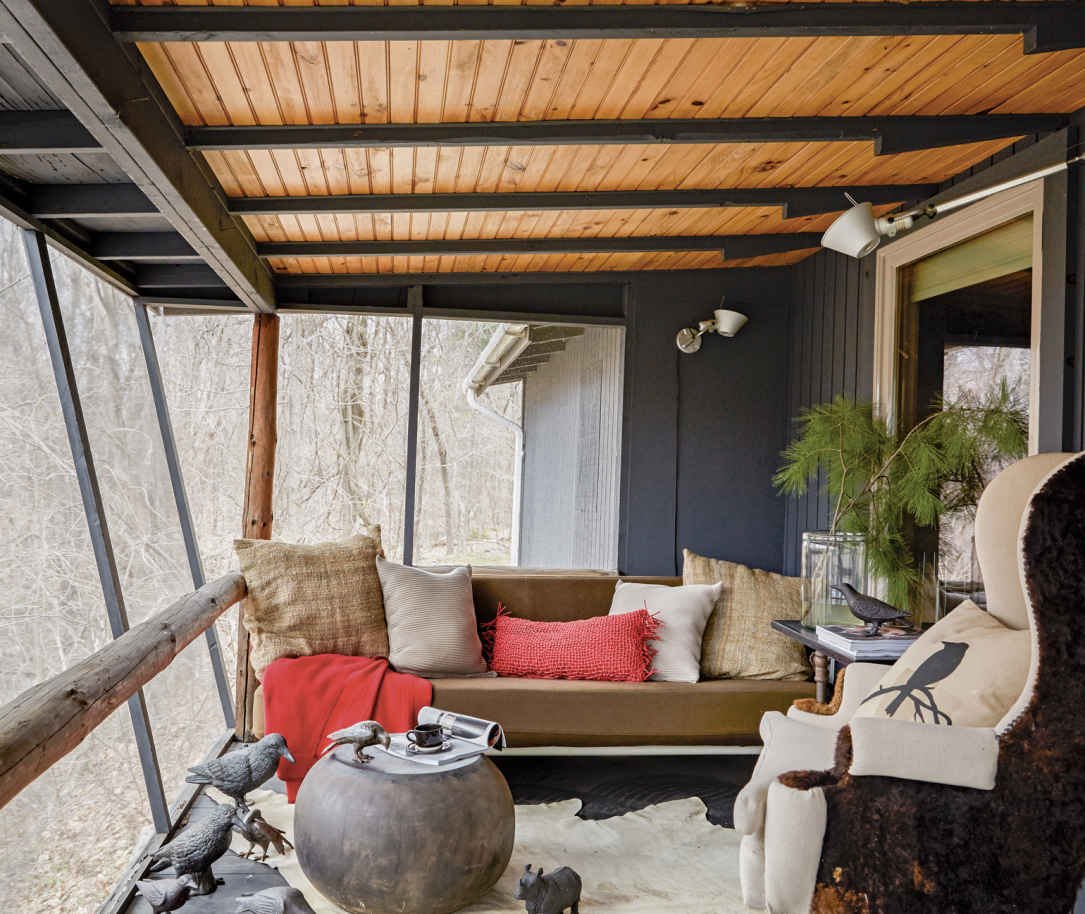 LEAN INTO IT. Instead of a basic, square-shaped screen porch, this one has a long wall set at a slight angle, which makes the closed-off room feel more open.